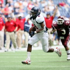 Two African American football players on the playing field