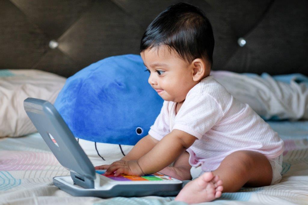 Determined infant uses laptop