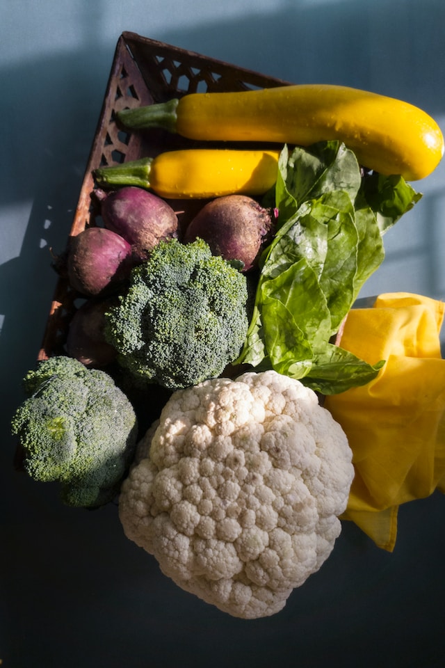 Overhead view of green, red, white, and yellow vegetables.